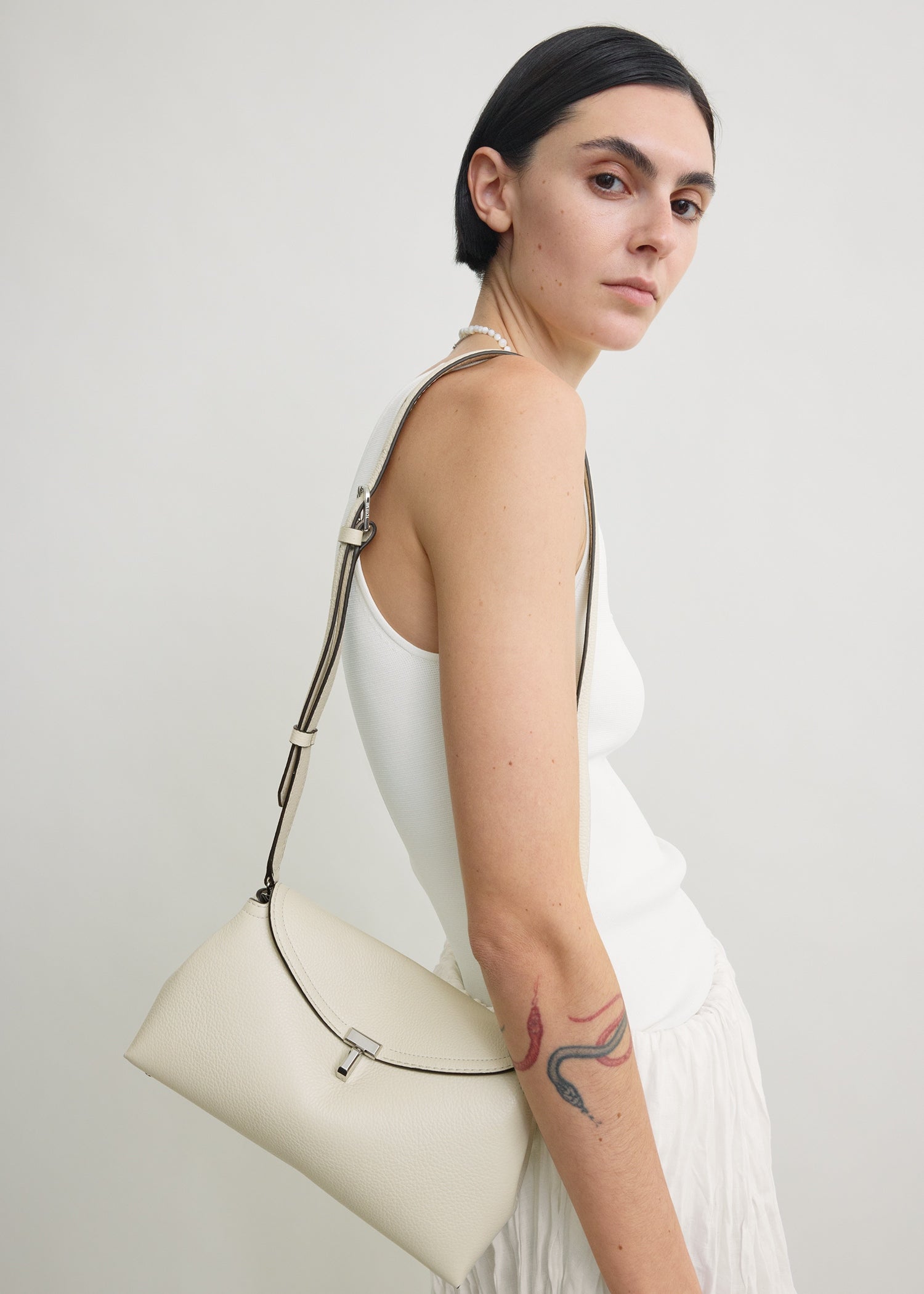 T-lock grained-leather clutch milk
